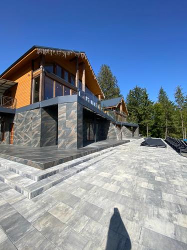 a shadow of a person standing in front of a house at SevenHills chalet in Yablunytsya