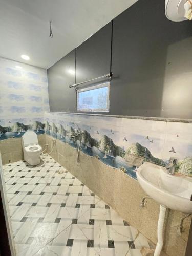a bathroom with a dinosaur mural on the wall at Gayatri Dham in Vrindāvan
