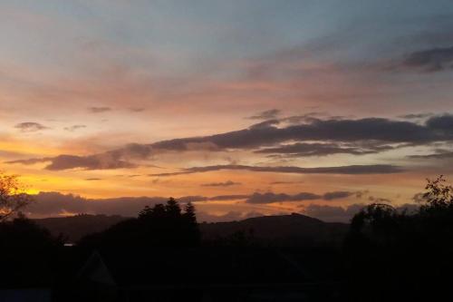 a view of a sunset with clouds in the sky at Bed and Breakfast Happy Home Taupo Accommodation in Taupo