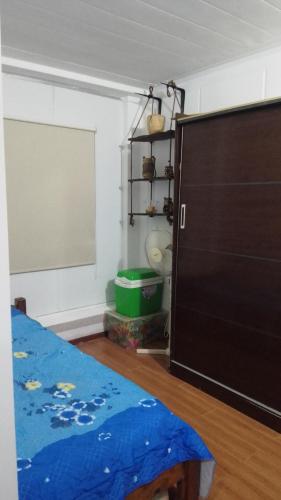 a room with a bed and a large door at Tu lugar de relax a 2 cuadras de la playa Se reserva con seña in Guazuvira