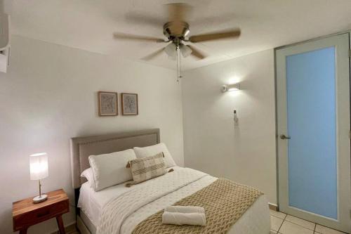 a bedroom with a bed with a ceiling fan at Islabella Guest House in Isabela