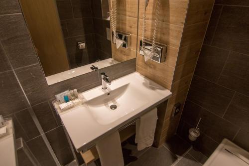 a bathroom with a sink and a mirror at Holiday Inn Budapest-Budaörs by IHG in Budaörs