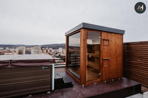 a small wooden cabin on the roof of a building at Albelli Luxury Skyview in Košice