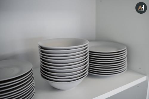 a stack of plates sitting on a shelf at Albelli Luxury Skyview in Košice