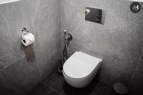 a bathroom with a white toilet in a stall at Albelli Luxury Skyview in Košice