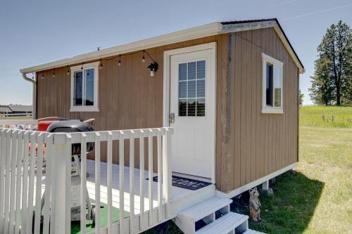 a tiny house with a white door on a deck at Eagle’s Landing Lodge in Custer