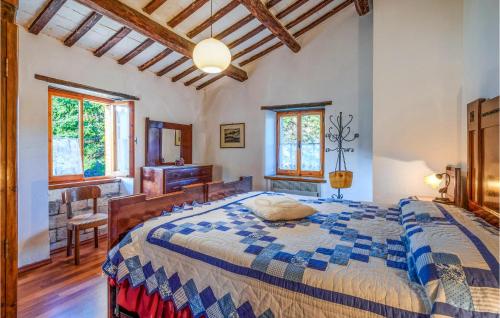 a bedroom with a large bed in a room with windows at 4 Bedroom Beautiful Home In Acqualagna in Acqualagna