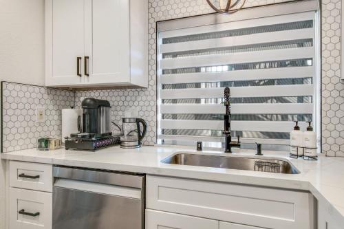 a kitchen with a sink and a microwave at Ritz Pointe Paradise! in Dana Point