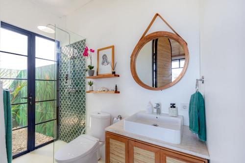 a bathroom with a sink and a mirror at THE SWAN BINGIN - 360 Ocean & Uluwatu Hills View in Bingin Beach in Uluwatu