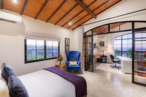 a bedroom with a bed and a desk in a room at THE SWAN BINGIN - 360 Ocean & Uluwatu Hills View in Bingin Beach in Uluwatu