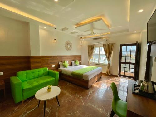 a bedroom with a green bed and a green couch at Wanna Stay Rishikesh in Rishīkesh