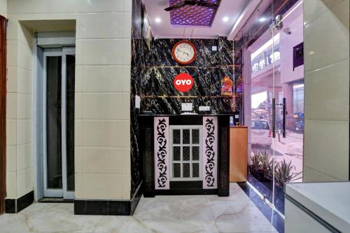 a store front with a clock on a wall at OYO Flagship Hotel Metro Height's near Nangloi Railway metro station in New Delhi