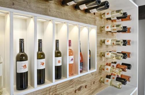 a wine cellar with bottles of wine on a wall at Farm Stay Jarc Vineyard in Svečina