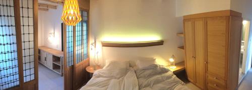 a bedroom with a bed with white sheets at Hotel Porto Loutro on the Hill in Loutro