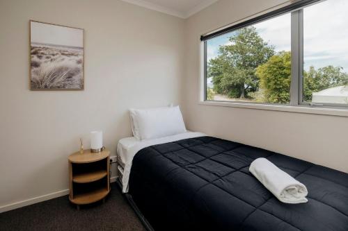 een slaapkamer met een bed en een raam bij Dorset Retreat in Hillsborough