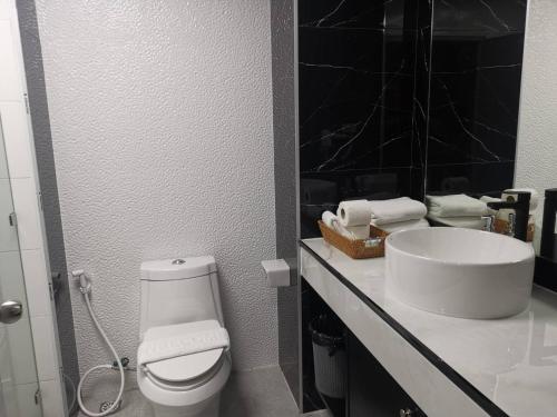a bathroom with a white toilet and a sink at View Talay6 by Blue Ocean Suite in Pattaya Central