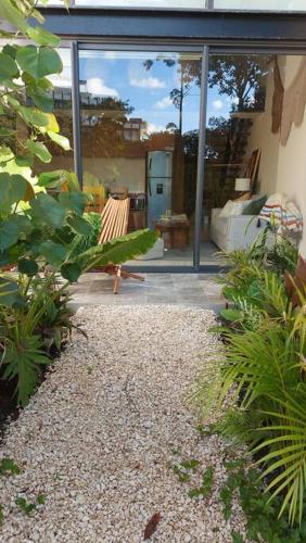 a patio with a bench and a large window at Beautiful Jungle Loft, 7 Pools, Free Beach Shuttle in Tulum