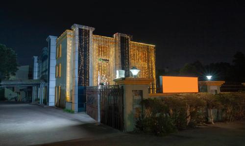 a large building with lights on it at night at Treebo Trend Y Hotels Elite - Jagamara in Bhubaneshwar