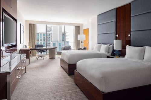 a hotel room with two beds and a desk at JW Marriott Marquis Miami in Miami