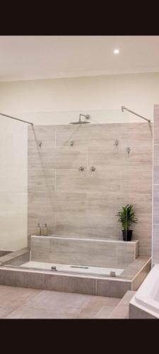 a bathroom with two sinks and a shower at Millwood House in Durban