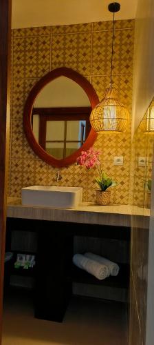 a bathroom with a sink and a mirror at ZiFa Mandalika in Kuta Lombok