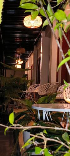 a room with chairs and plants and lights at ZiFa Mandalika in Kuta Lombok