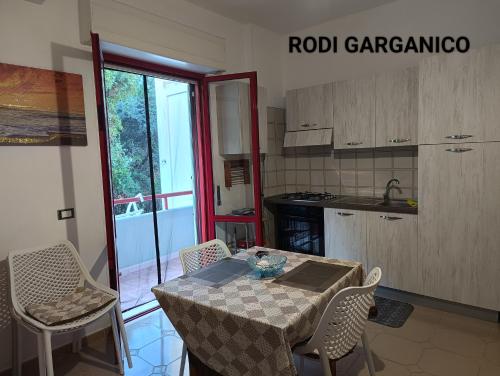 a kitchen with a table and chairs in a kitchen at Marechiaro in Foce Varano