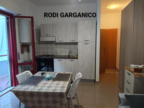 a kitchen with a table and chairs in a room at Marechiaro in Foce Varano