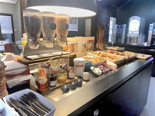 a buffet line with some food on a counter at Campanile Annecy - Cran Gevrier in Annecy