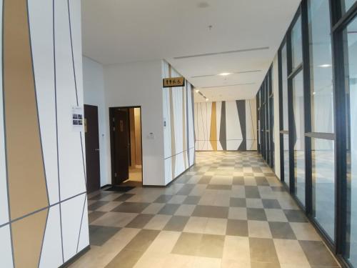 a hallway of an office building with a checkered floor at K AVENUE B17 house room near airport by Gc in Kota Kinabalu