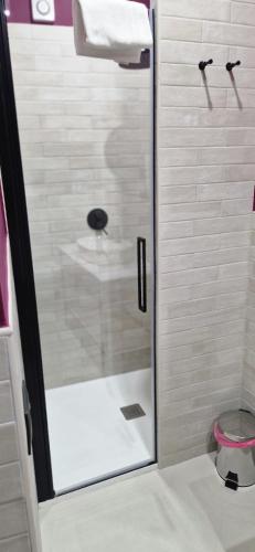 a shower with a glass door in a bathroom at Blu room in Taranto