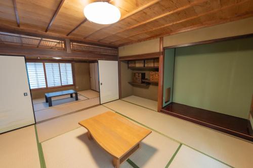 a room with a table and a projection screen at Private Chill Base たまて 三豊市荘内半島の古民家宿 一棟貸しも可 in Mitoyo