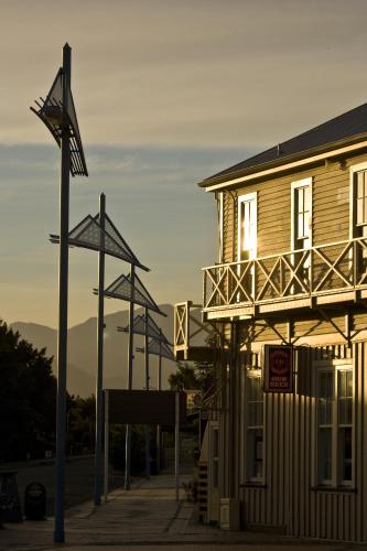 a wooden building with a balcony on a street at Abisko Lodge in Methven