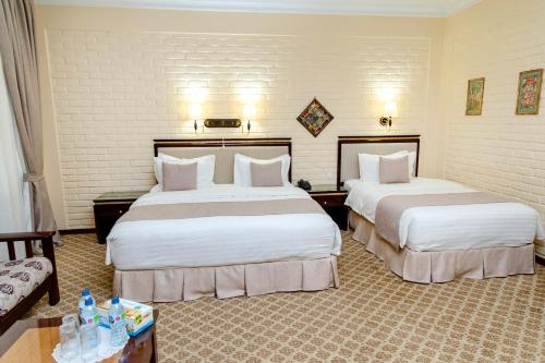 Un ou plusieurs lits dans un hébergement de l'établissement Hotel Grand Samarkand Superior - A