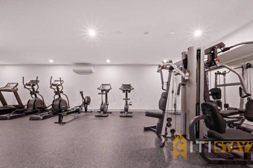 a gym with several tread machines in a room at Lovely in Lyneham - 1bd 1bth Apt in Canberra