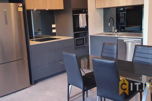a kitchen with a table and chairs and a sink at Lovely in Lyneham - 1bd 1bth Apt in Canberra