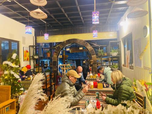 a group of people standing at a counter in a store at En Hotel Sapa in Sa Pa