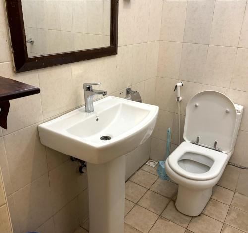 a bathroom with a sink and a toilet at Princess Salme Inn in Zanzibar City