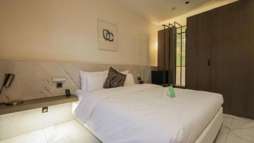 a bedroom with a large white bed in it at Pangyo Business & Tourist Hotel KYND in Seongnam