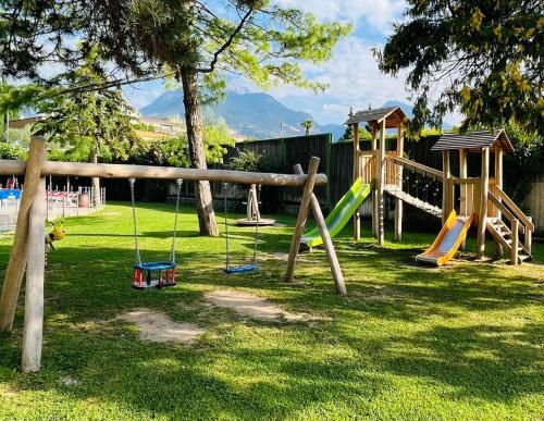 a park with a playground with slides and swings at Garda Sporting Club Hotel in Riva del Garda