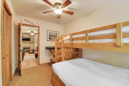 a bedroom with two bunk beds and a ceiling fan at Serenity Suite in Arnold