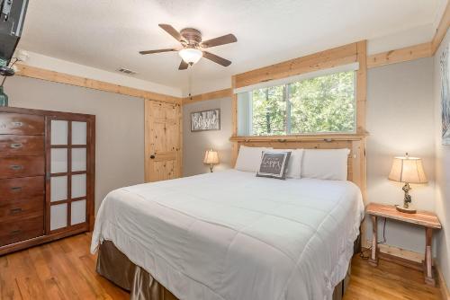 a bedroom with a bed and a ceiling fan at Cozy Bear Cabin in Arnold