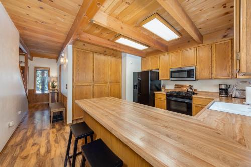 a kitchen with wooden cabinets and a large counter top at Evergreen Lodge in Arnold