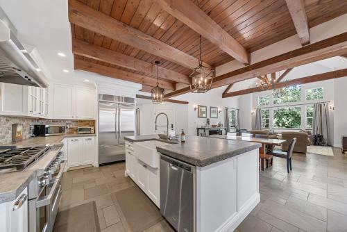 a large kitchen with white cabinets and a table at Yellowdog Inn in Arnold