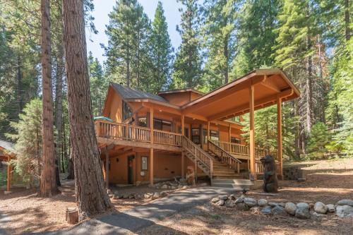 a house in the woods with a wrap around deck at Sequoia Ridge in Dorrington