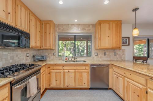 a kitchen with wooden cabinets and stainless steel appliances at Sequoia Ridge in Dorrington