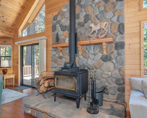 a fireplace in a living room with a stone wall at Sequoia Ridge in Dorrington