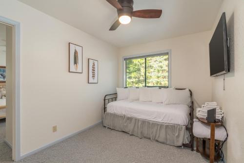 a white bedroom with a bed and a ceiling fan at Sequoia Ridge in Dorrington