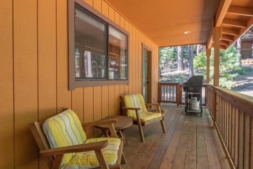 a porch with two chairs and a grill on it at Sequoia Ridge in Dorrington