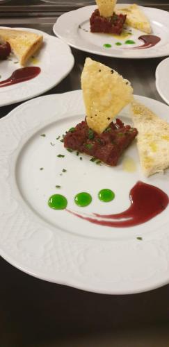 a white plate with food on a table at Eirl DOLOMITES Retreat Sappada in Sappada